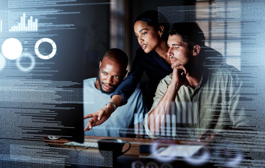 woman and two men working on a computer with computer code overlaying the image.